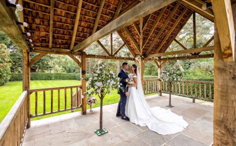 A couple beneath the timber garden pavilion, West Lodge Park