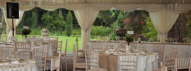 Marquee set with tables on the lawn, West Lodge Park