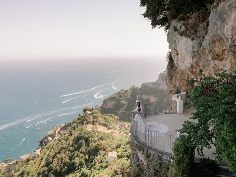 Aerial: a couple embracing on a cliffside terrace above the Amalfi Coast, White Emotion