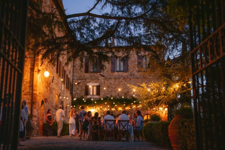 An evening courtyard dinner beneath string lights, Borgo Castelvecchio, Tuscany, White Emotion