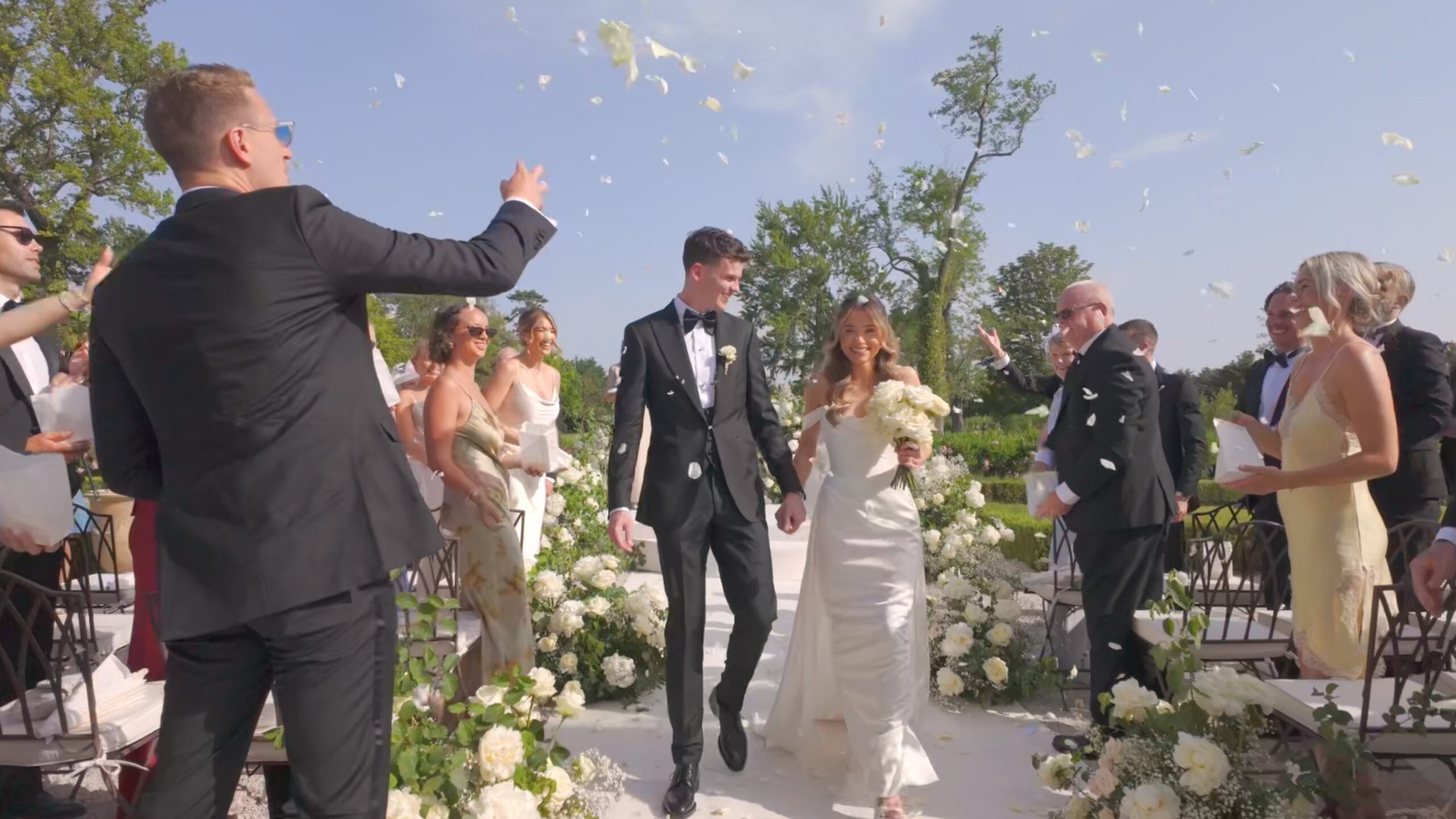 Charlotte and Sam leave their ceremony under confetti at Château de Tourreau, Provence (film still), Whitesfilm Wedding Videography