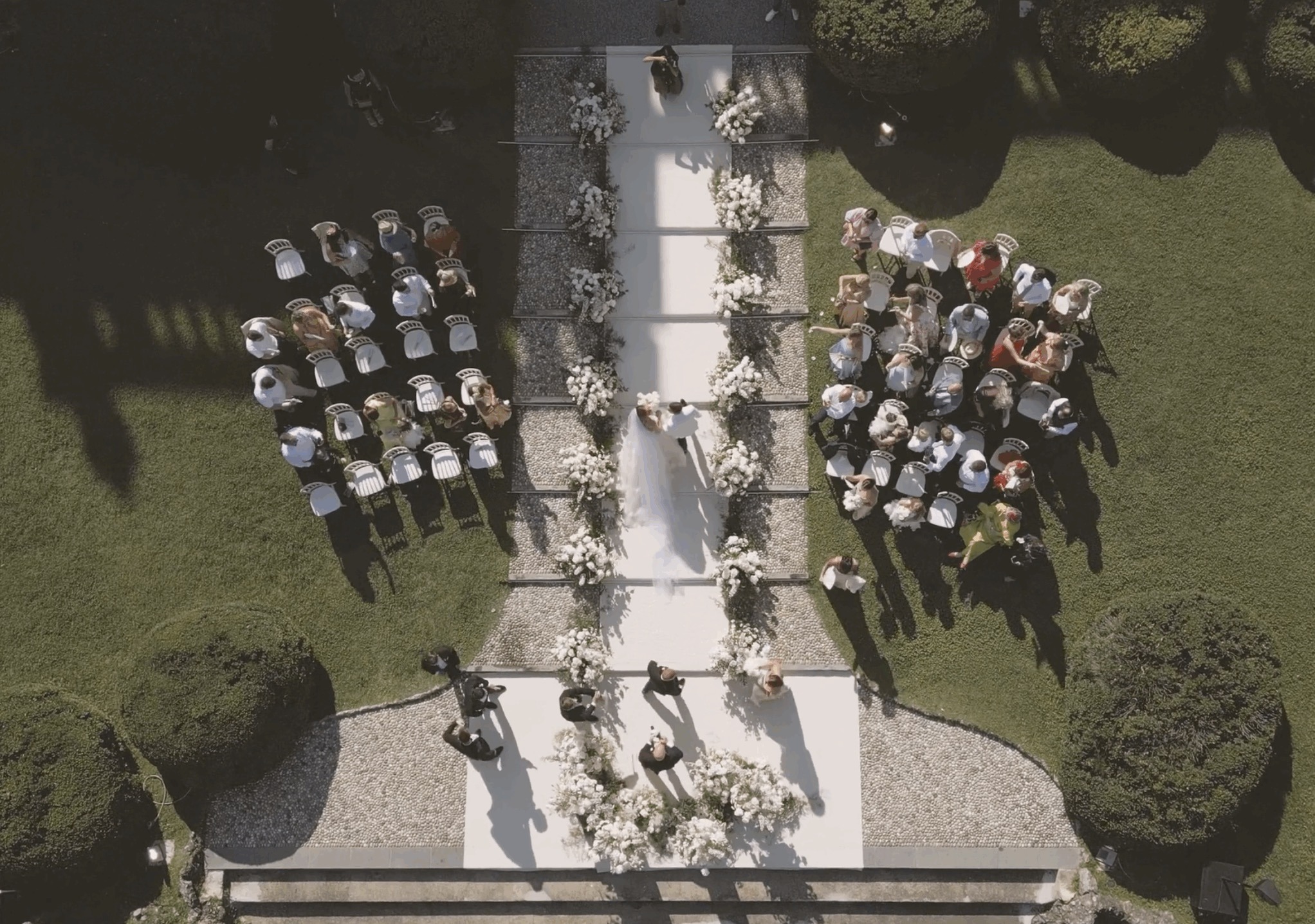 Aerial view of the garden ceremony aisle for Emily and Darren at Villa Erba, Lake Como (film still), Whitesfilm Wedding Videography