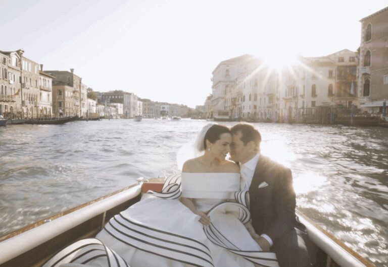 A couple in a launch on the Grand Canal, Venice, the low sun behind the palazzi, Whitesfilm Wedding Videography