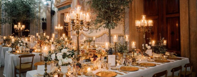 A banquet table under candelabra and olive trees in a frescoed Italian hall, Whitesfilm Wedding Videography