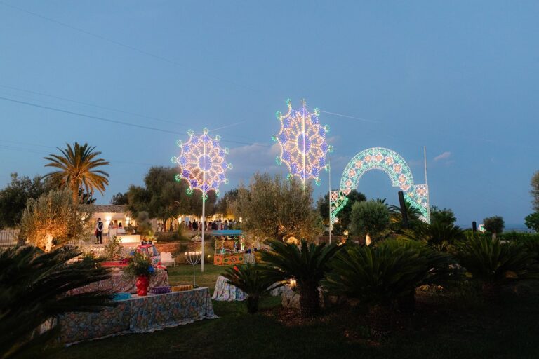 Sicilian festival lights over the garden at a wedding in Sicily, at blue hour, Whitesfilm Wedding Videography