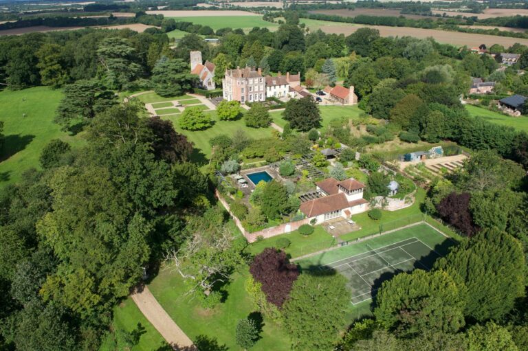The wider estate from the air: the house, the walled garden, the tennis court and woodland, Wickham House