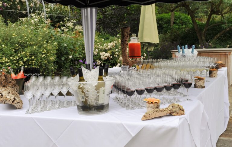 A drinks table in the garden laid with glasses of wine and champagne, Wickham House