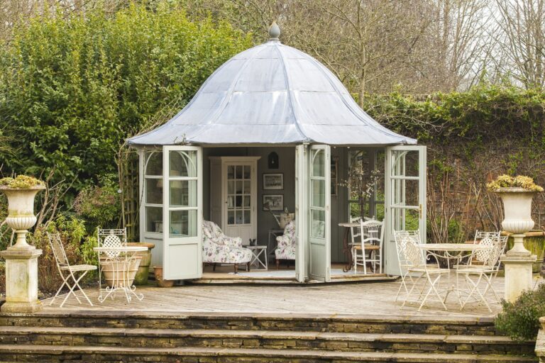 The summer house in the walled garden, with its doors open onto a terrace, Wickham House