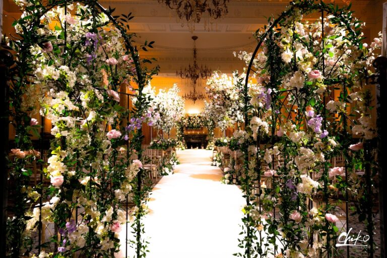 A floral archway lines the aisle, Wildabout