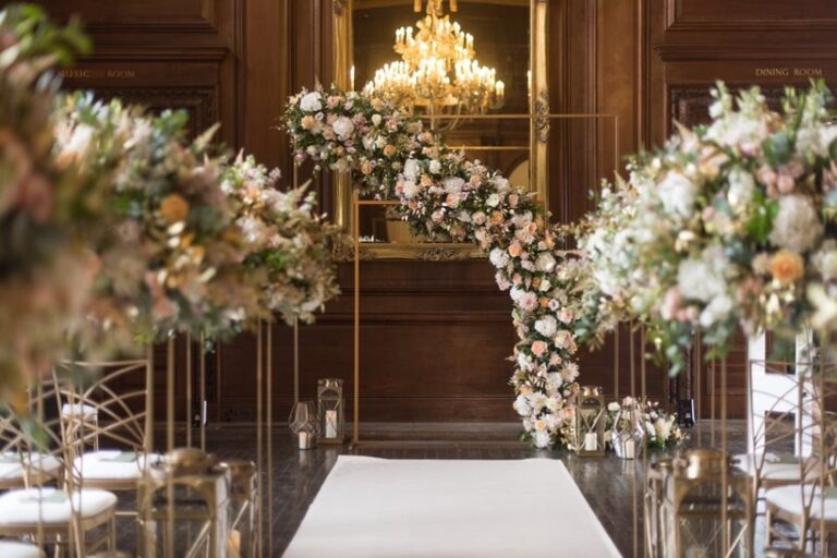 A candlelit ceremony arch in a wood-panelled room, Wildabout