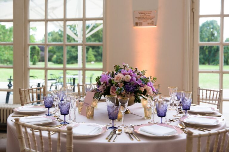 A candlelit wedding table in the Orangery at Kew Gardens, Wildabout