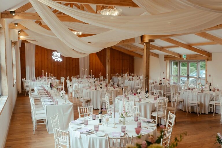 The Mulberry Room set with round tables and white chairs, timber posts and doors opening to the outside, Worstead Estate