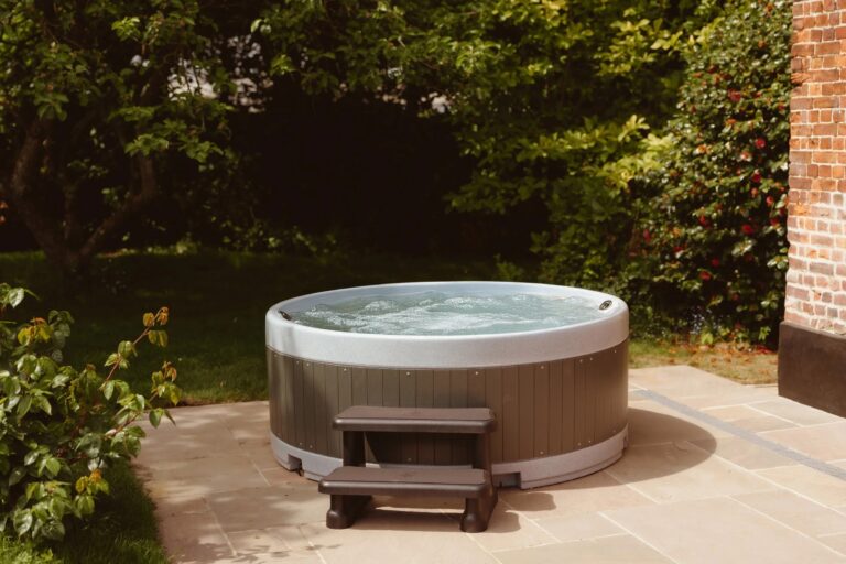 The private hot tub on the paved terrace at Swann Cottage, Worstead Estate