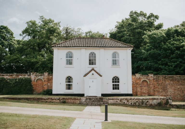 Estate Cottage, the former head gardener's house opposite The Woodyard, set against its brick garden wall, Worstead Estate