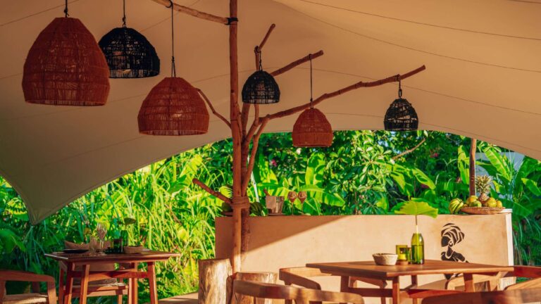 Covered restaurant terrace with rattan lanterns, Ycona Luxury Resort