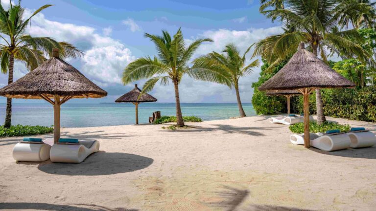 The beach with thatched parasols and sun beds, Ycona Luxury Resort