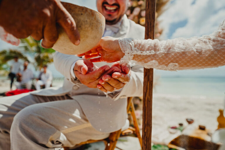 Hands joined in a ceremony ritual on the beach, YD Events