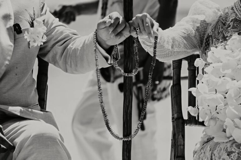 Rosary beads held during a religious ceremony, in black and white, YD Events
