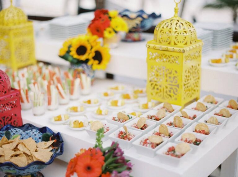 A canape table dressed with sunflowers, gerberas and yellow lanterns, YD Events