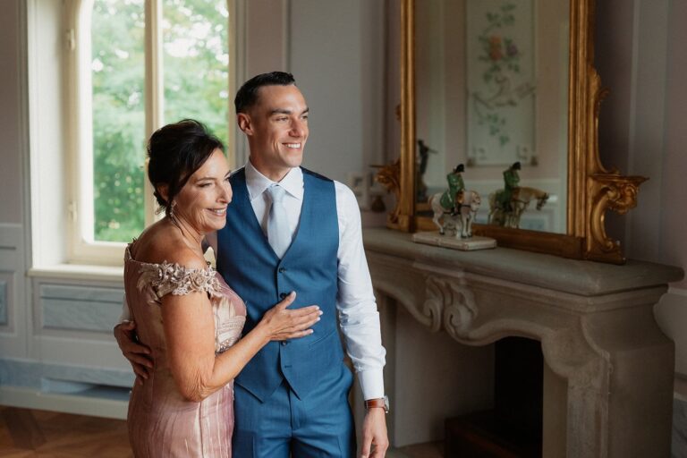 A candid embrace between a groom and his mother beside an antique gilt mirror, Your Secret Tuscany